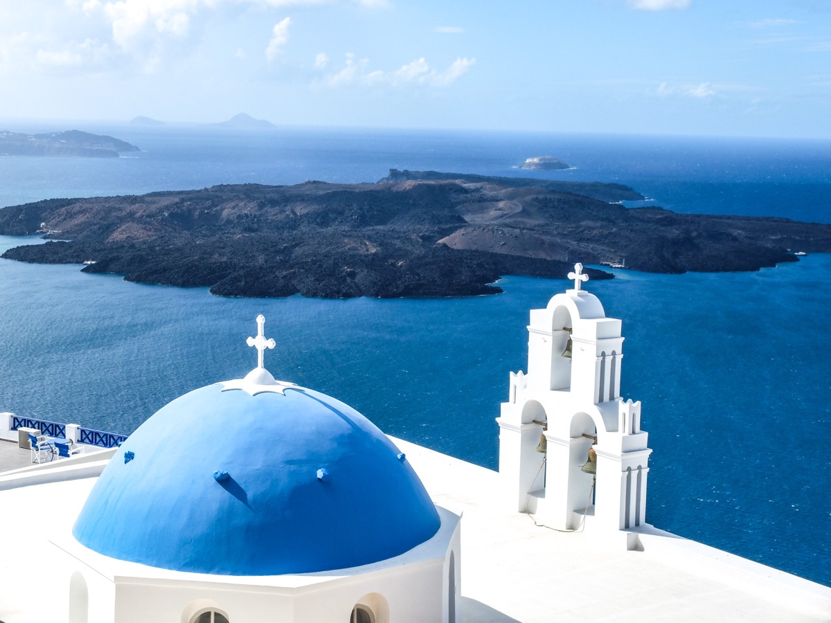 Santorini caldera view with white buildings and blue sea