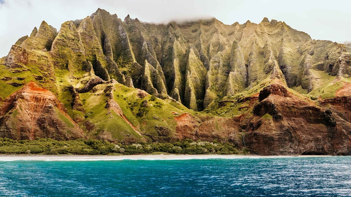 An aerial view of the dramatic cliffs of the Nā Pali Coast in Kauai, Hawaii