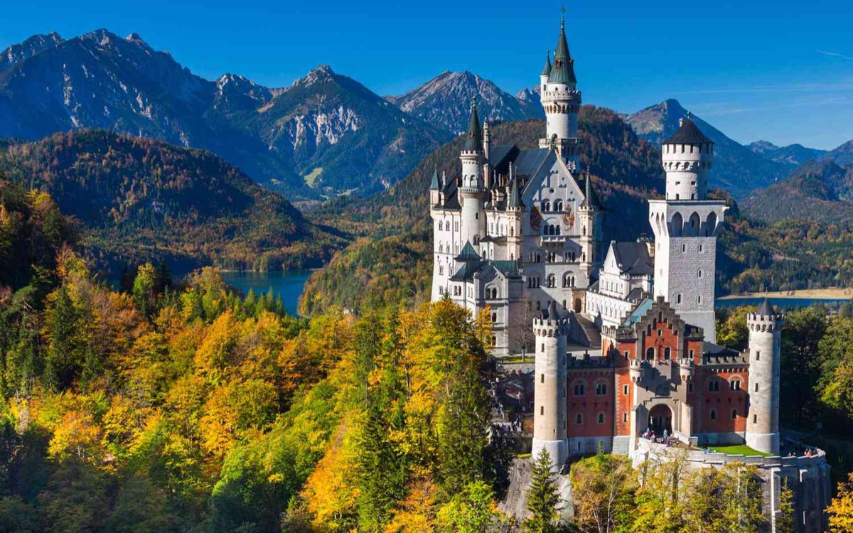 Neuschwanstein Castle surrounded by autumn forest, Bavaria