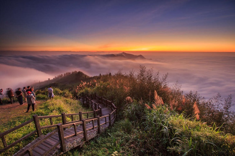 Alishan sea of clouds at sunrise with mountains emerging above the mist