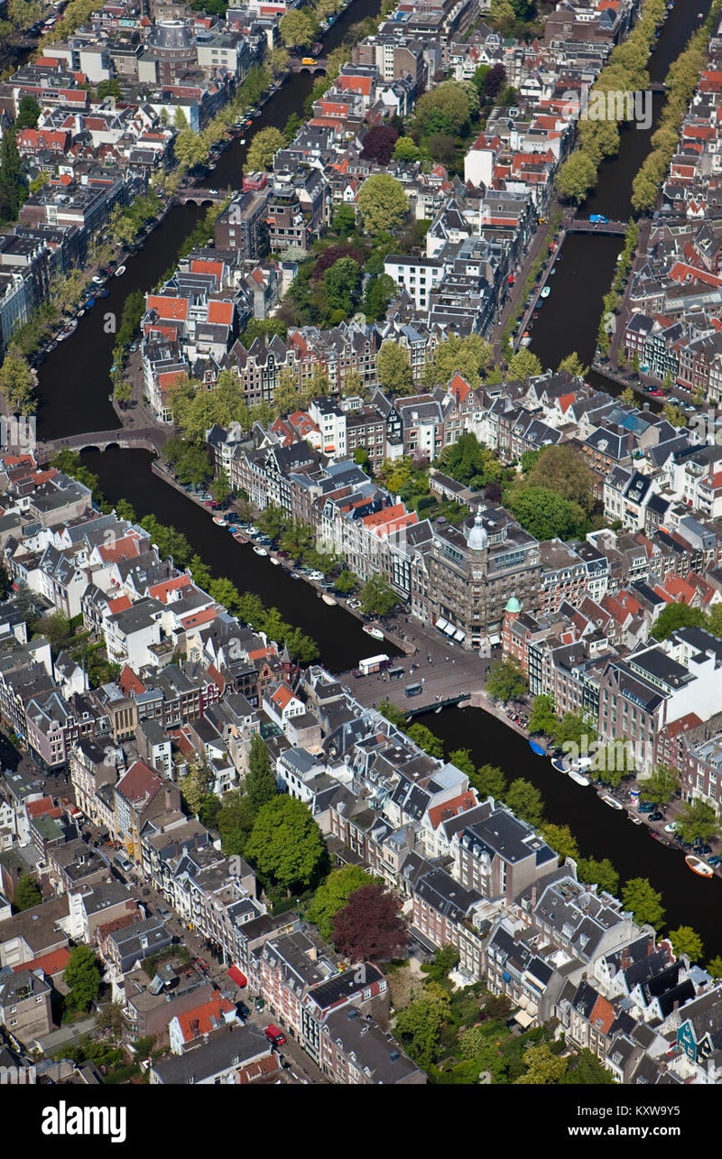 Amsterdam's iconic 17th-century canal ring with narrow gabled houses reflected in still water