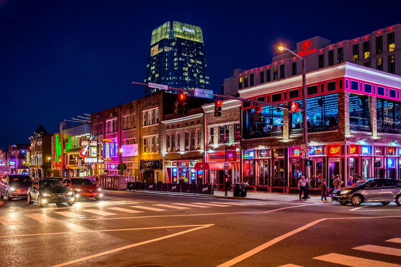 Broadway Street in Nashville Tennessee with lit-up honky tonk bars at night