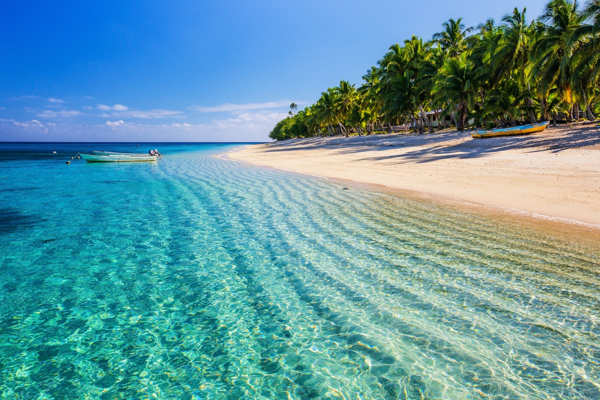 Crystal-clear turquoise waters and white sand beach in Fiji