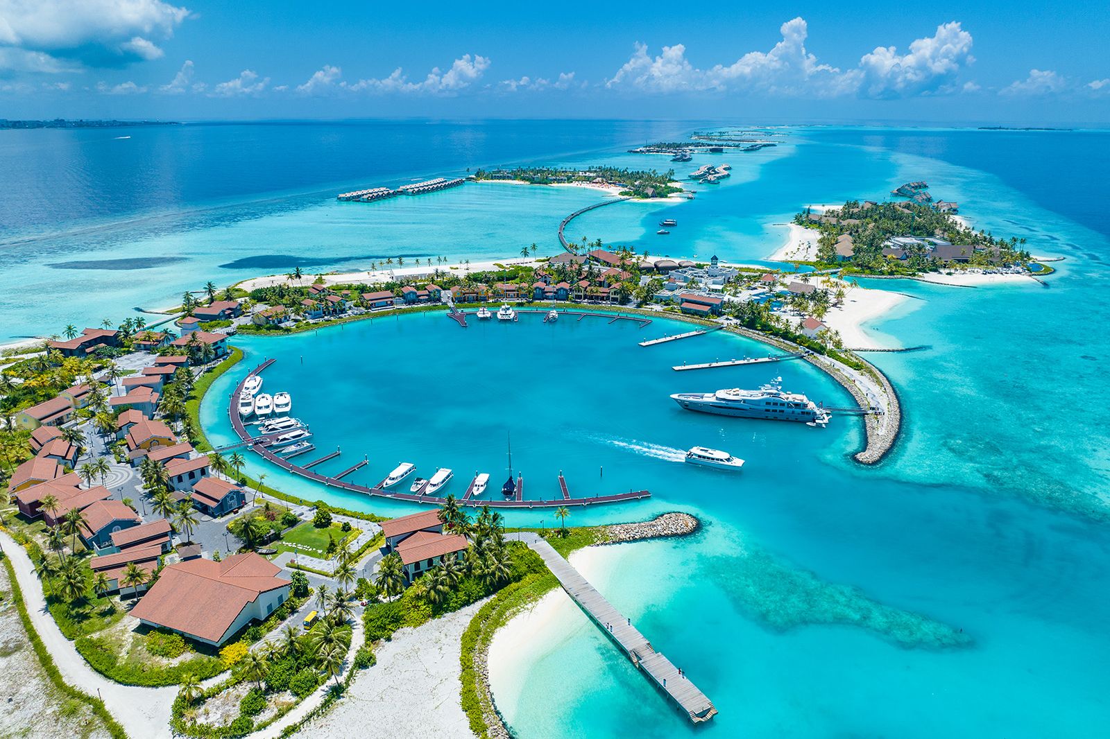 Aerial view of a Maldives coral atoll with turquoise lagoon and white sand