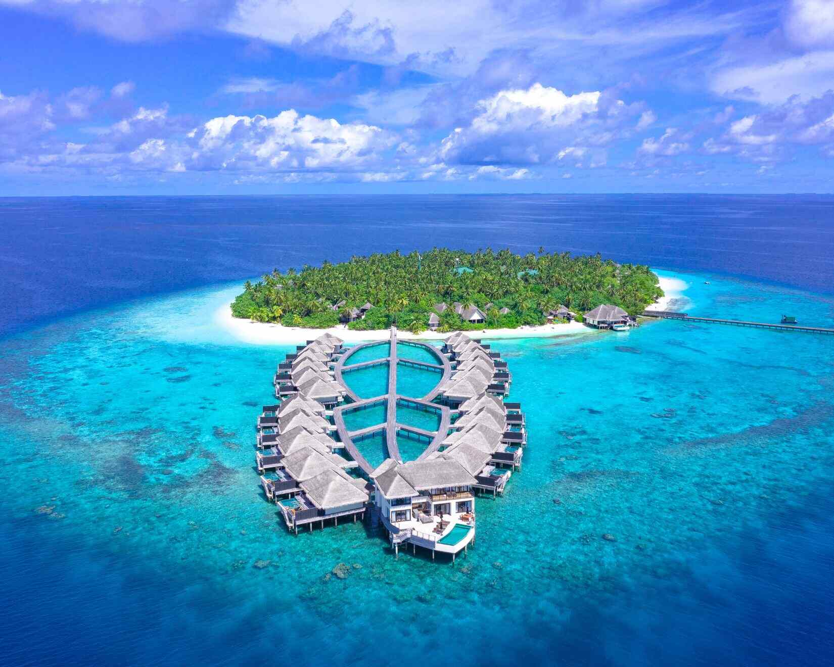 Overwater bungalows above turquoise lagoon in the Maldives
