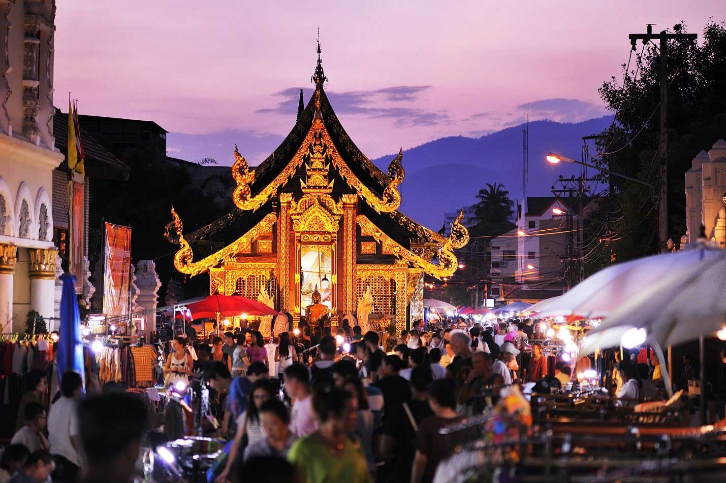 Chiang Mai Night Bazaar, Thailand — neon-lit market stalls line the street at night
