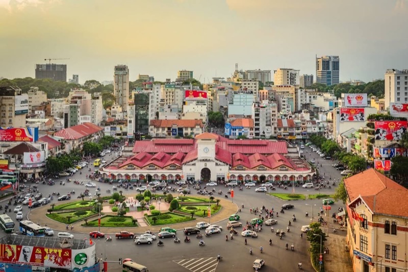 Ho Chi Minh City Ben Thanh Market area at dusk with bustling street market stalls and local Vietnamese vendors