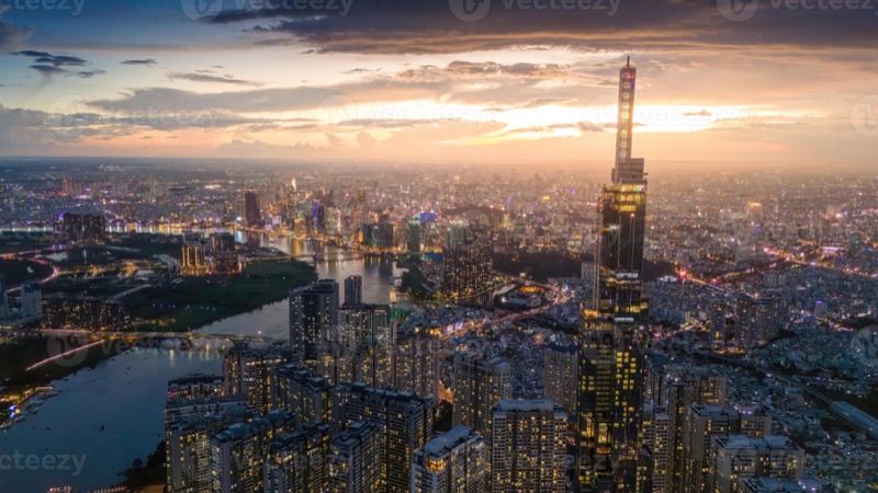 Ho Chi Minh City aerial skyline at night with the Saigon River winding through the glittering cityscape