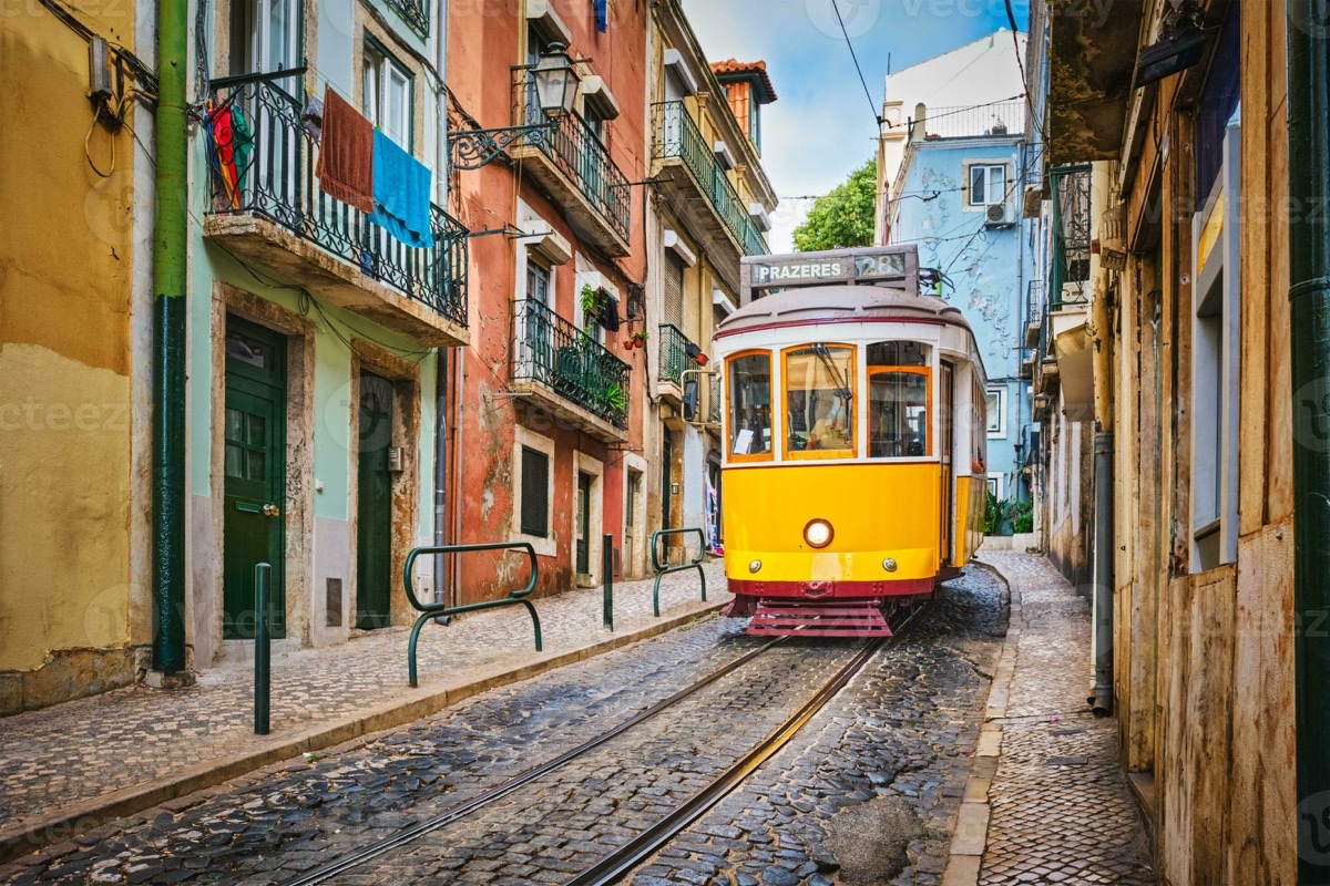 Iconic yellow Tram 28 winding through Alfama's narrow streets, Lisbon, Portugal
