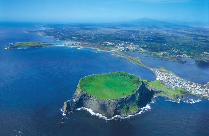 Jeju Island volcanic landscape with lush green hills and scenic coastline
