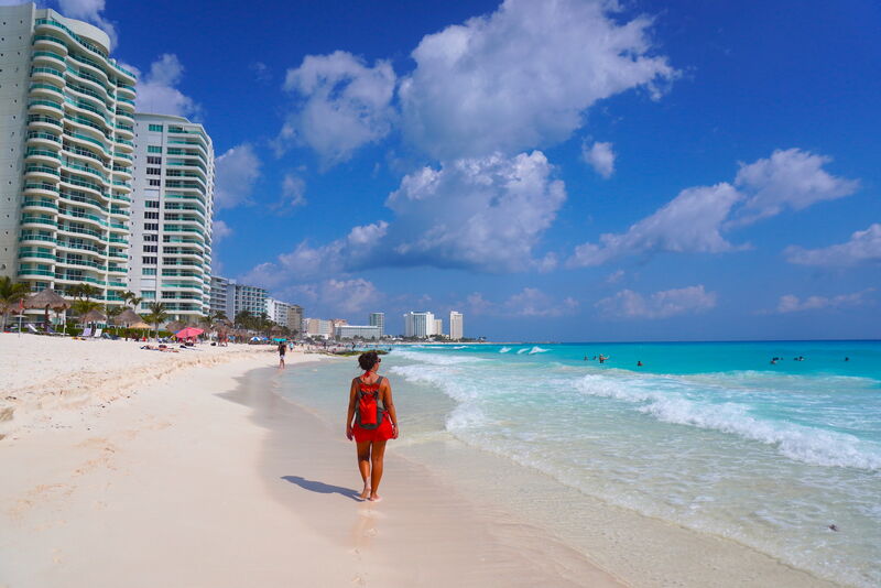 Cancun Hotel Zone beach with turquoise Caribbean water and resort skyline