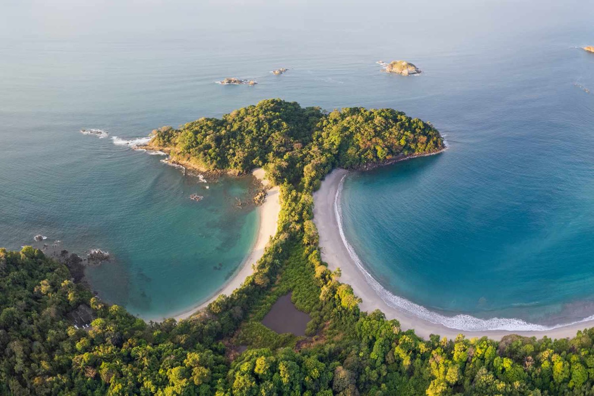 Manuel Antonio beach in Costa Rica — lush rainforest meets white sand and turquoise Pacific waters