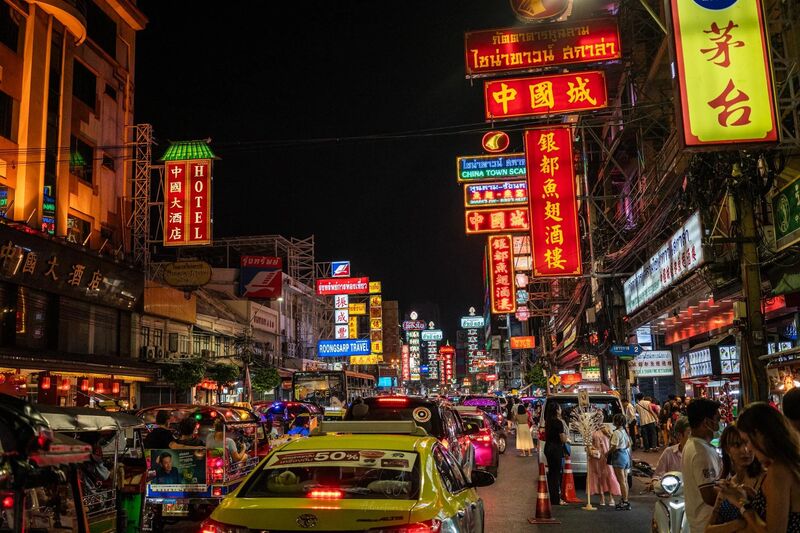Bangkok Yaowarat Chinatown at night — neon signs and street food vendors illuminate the famous Bangkok night market street