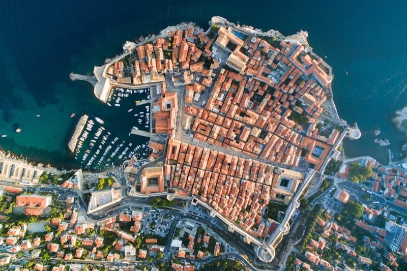 Aerial view of Dubrovnik Old Town with ancient city walls and terracotta rooftops above the Adriatic Sea
