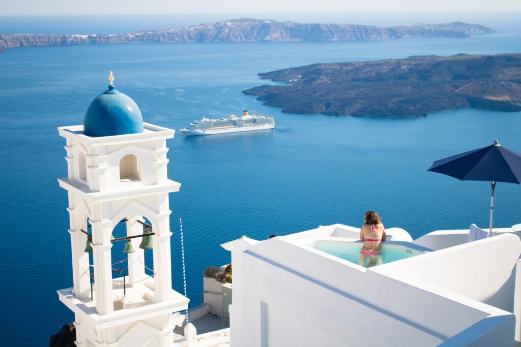 Santorini, Greece — iconic blue-domed churches and whitewashed buildings over the caldera