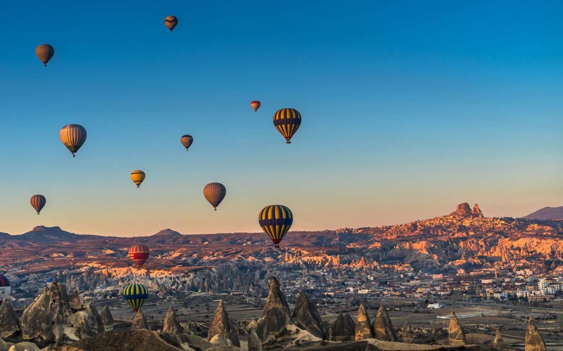 Hot air balloons over Cappadocia's fairy chimneys and volcanic landscape, Turkey