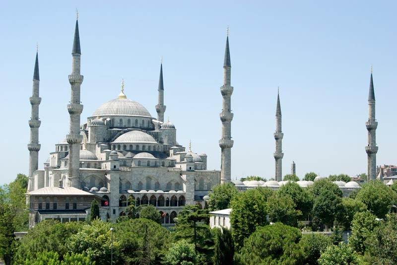 Istanbul's Blue Mosque at sunset, with minarets reflected in the Bosphorus