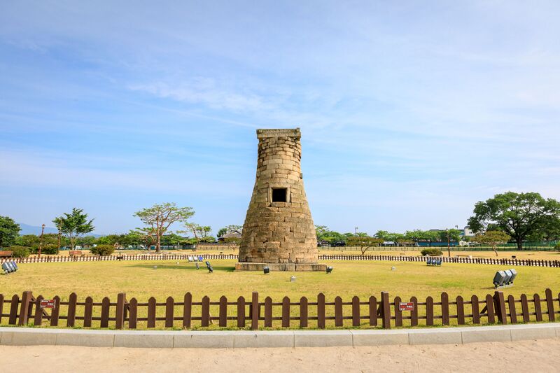 Tumuli Park in Gyeongju, with massive grassy royal burial mounds of the Silla Dynasty kings rising against a blue sky
