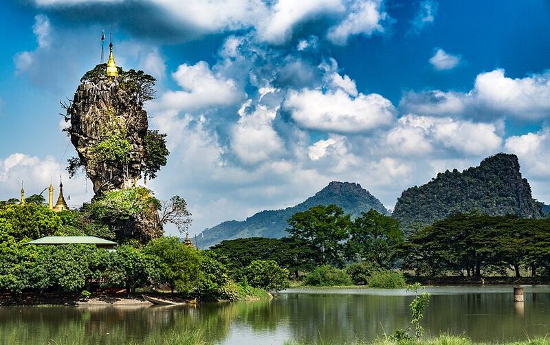 Hpa-An Myanmar — Kyauk Ka Lat Pagoda perched on a dramatic limestone needle rising from a lake
