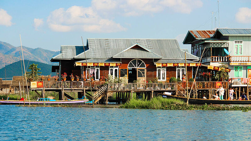 Inle Lake Myanmar — traditional floating market and longboats on the serene lake