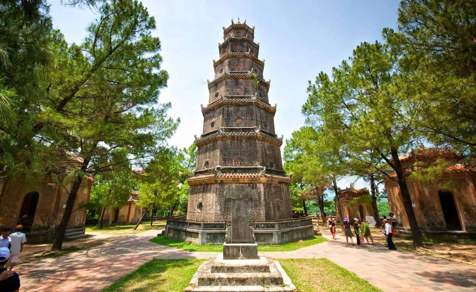 Thien Mu Pagoda on the Perfume River in Hue, Vietnam — a seven-story octagonal tower surrounded by lush trees