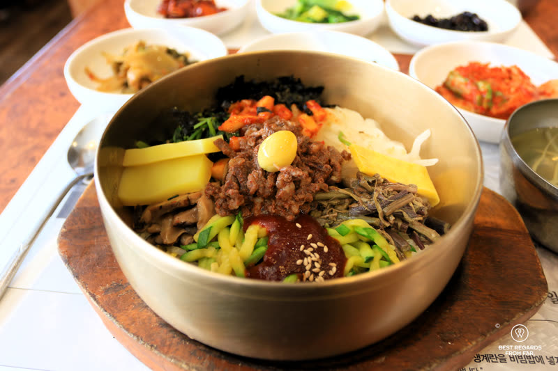 Traditional Jeonju bibimbap served in a stone pot with colorful vegetable toppings and red gochujang