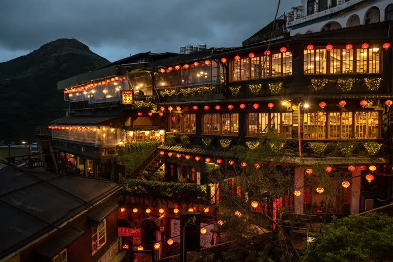 Jiufen Old Street at dusk with red lanterns glowing over the narrow alleys
