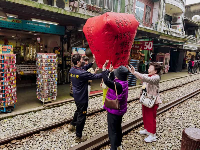 Sky lanterns rising above Shifen Old Street at night, Taiwan