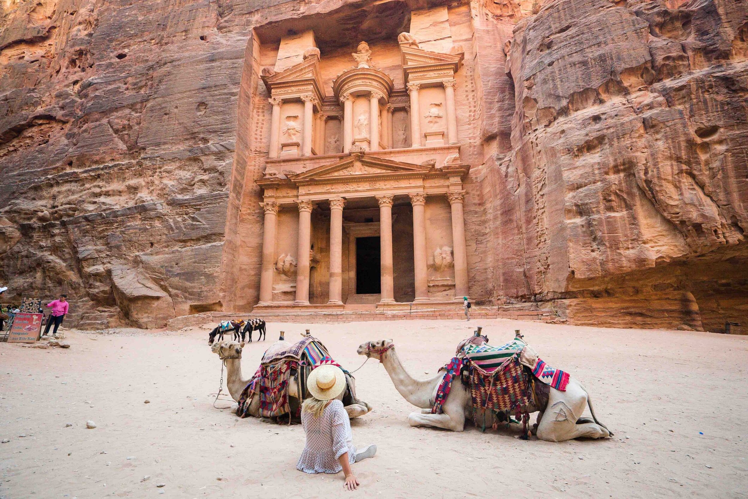 The iconic Treasury (Al-Khazneh) at Petra, Jordan — rose-red rock-carved facade revealed at the end of the narrow Siq canyon
