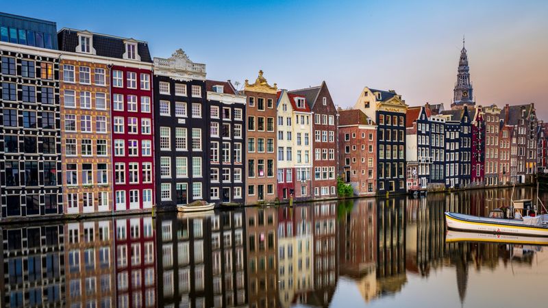 Iconic canal houses reflecting in Amsterdam's Prinsengracht canal