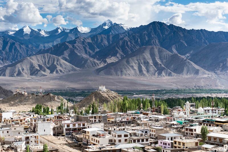 Leh city in Ladakh, surrounded by stark desert mountains at high altitude with clear blue sky
