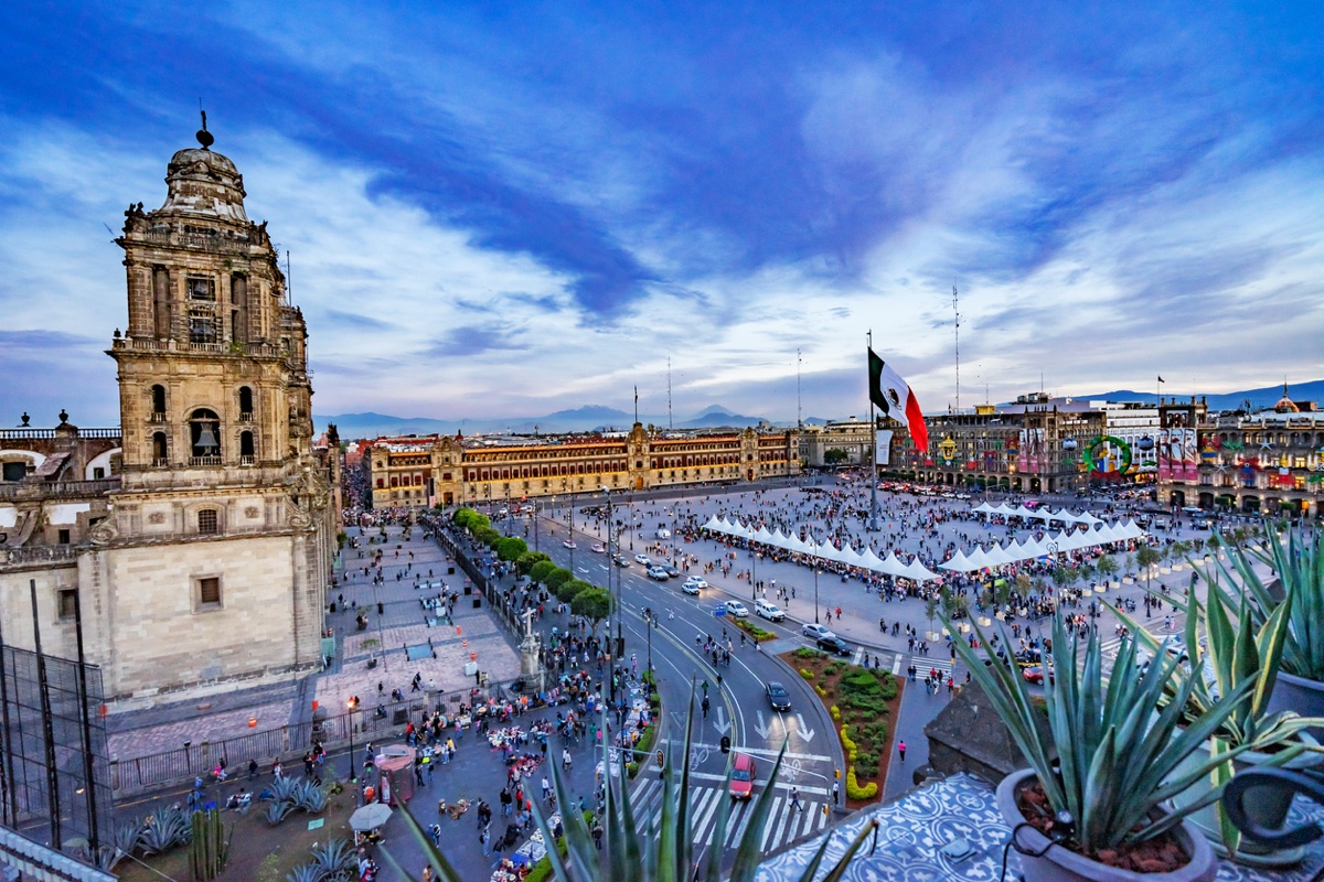 Mexico City Zocalo historic center at evening — Metropolitan Cathedral and Palacio Nacional illuminated