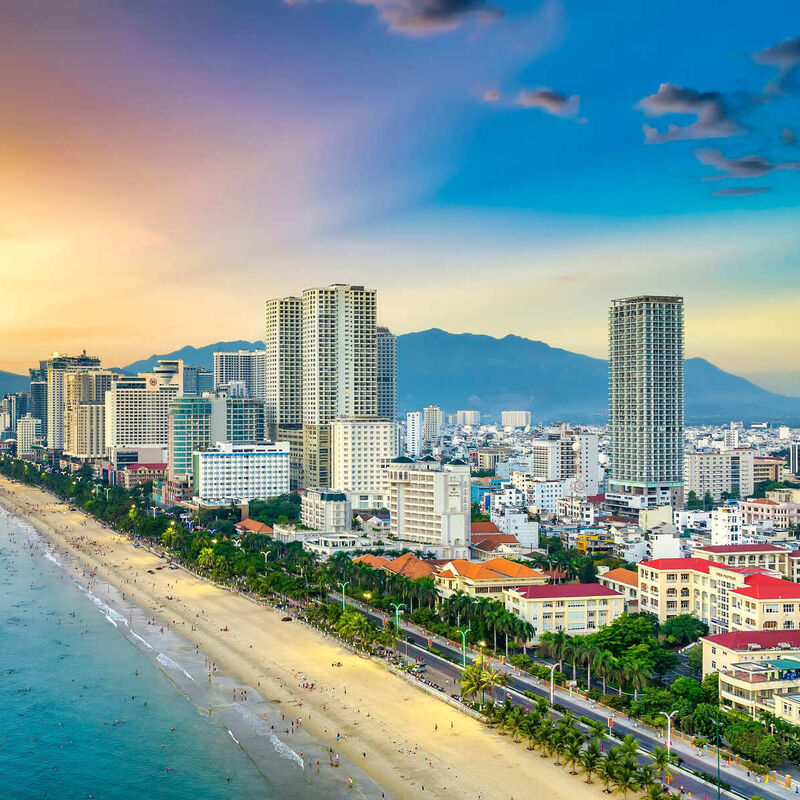 Aerial view of Nha Trang's coastal city and long sandy beach curving along the South China Sea