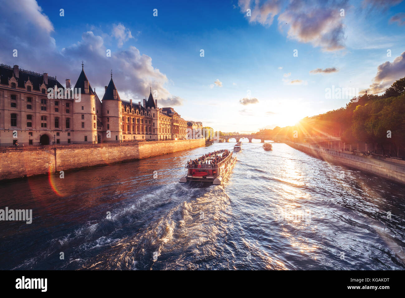 Dramatic sunset over the River Seine in Paris, France, with the Conciergerie