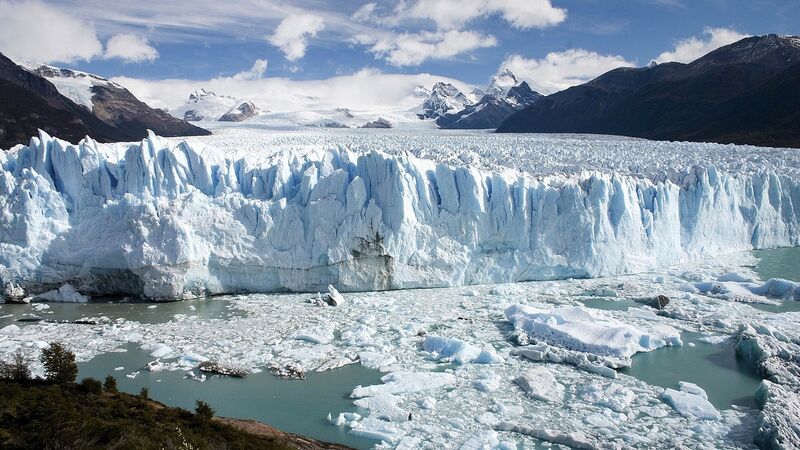 Perito Moreno glacier in Patagonia Argentina — massive blue ice wall calving into turquoise lake