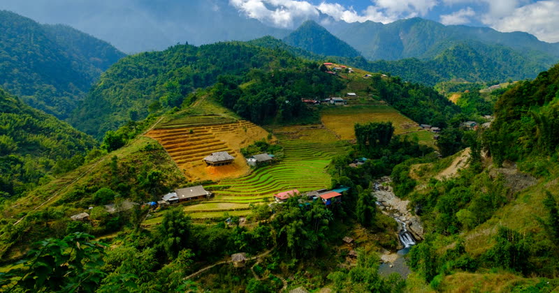 Hmong women in traditional colorful dress near a village market in northern Vietnam