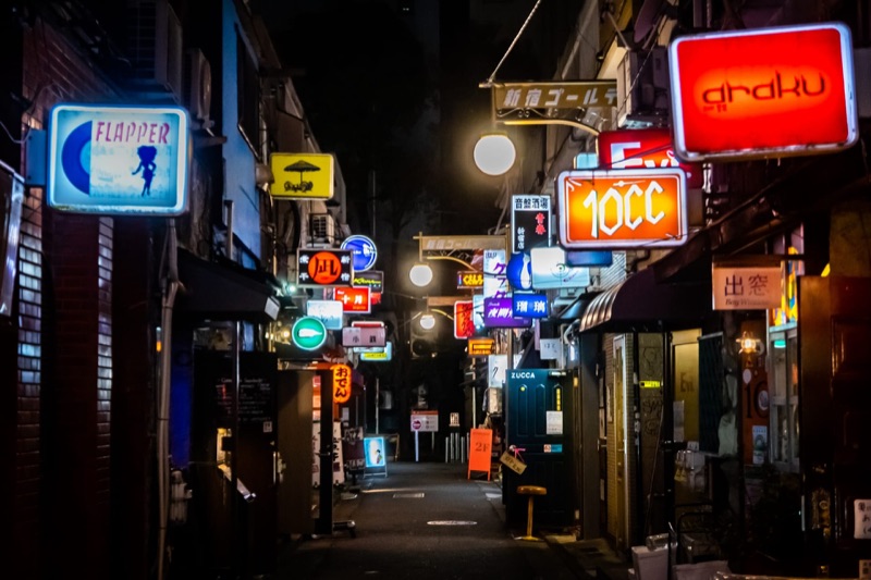 The narrow alleyways of Golden Gai in Shinjuku, lined with dozens of tiny bars lit up at night