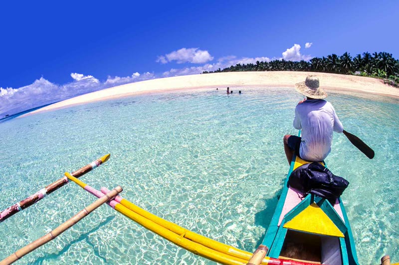 Siargao island beach with turquoise water and palm trees, Philippines