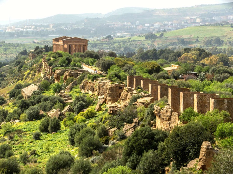 Valley of the Temples in Agrigento, Sicily — ancient Greek ruins standing against a blue Mediterranean sky