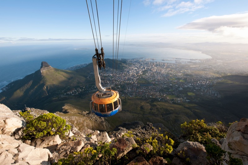 Cable car ascending Table Mountain above Cape Town, South Africa — iconic flat-topped mountain with the city and ocean below