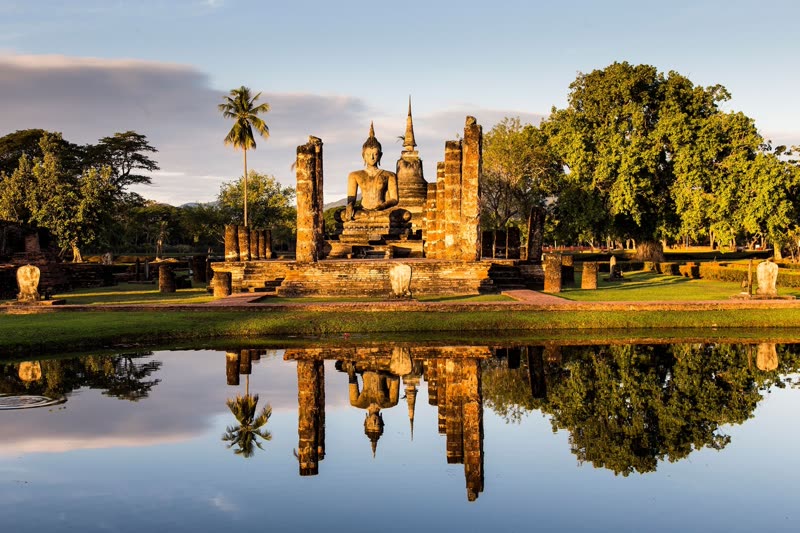 Sukhothai Historical Park with ancient Buddha statue and lotus pond