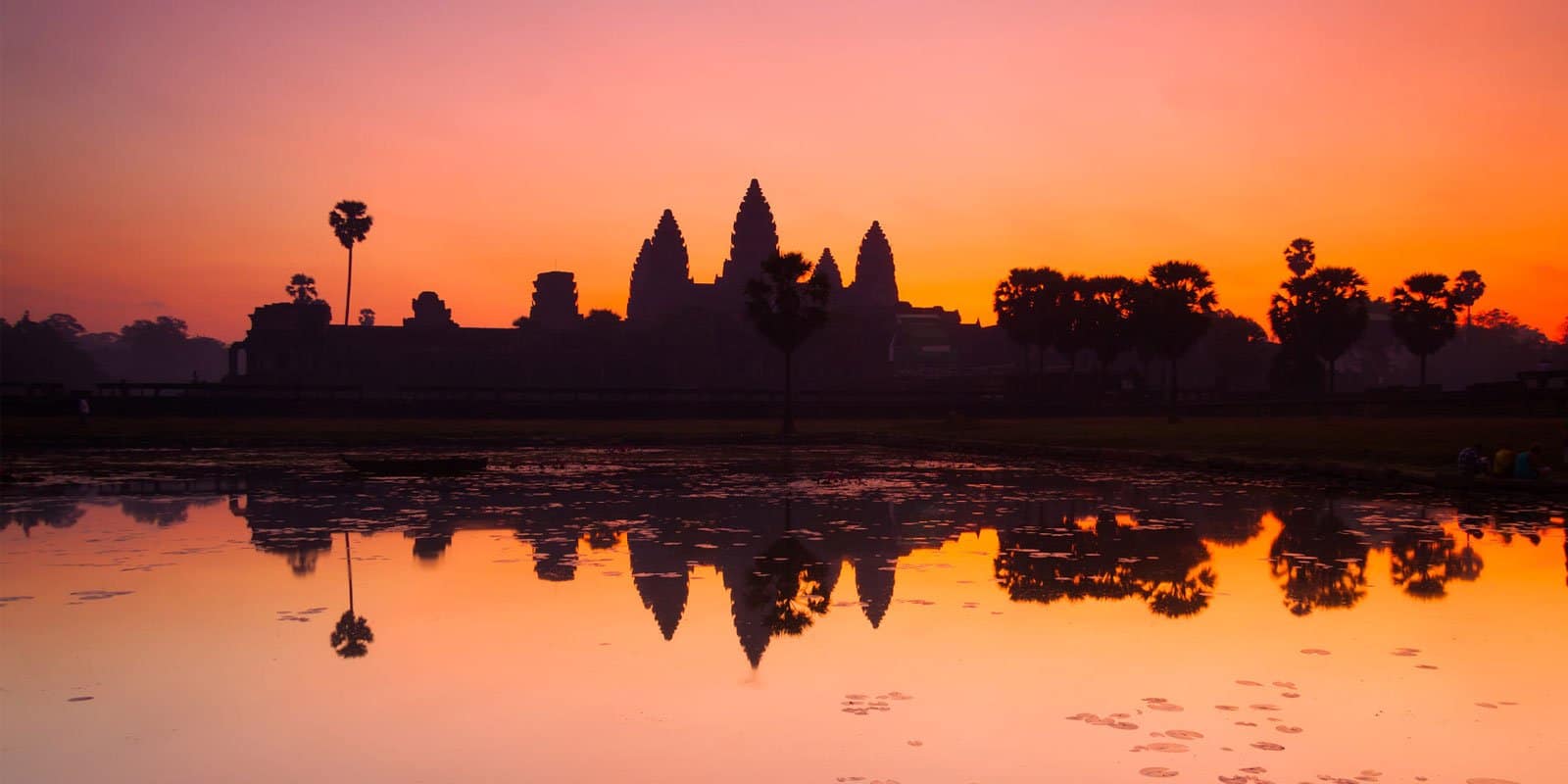 Angkor Wat at sunrise in Siem Reap, Cambodia — the world's largest religious monument reflected in still water