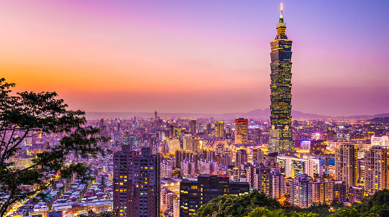 Taipei night market with street food stalls lit up at night, Taiwan