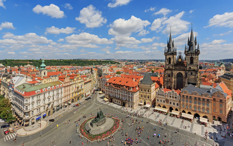 Prague Old Town Square aerial view with the Astronomical Clock tower and medieval Gothic architecture