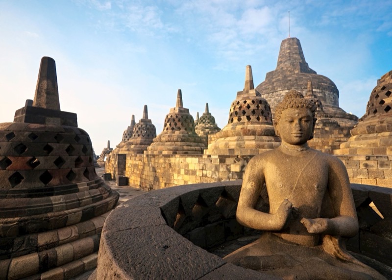 Borobudur Buddhist temple near Yogyakarta — the world's largest Buddhist monument with stone stupas at sunrise