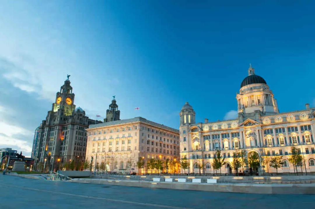 The majestic Royal Liver Building stands tall by the historic Albert Dock under a dramatic sky.