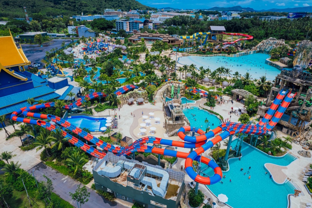 A majestic white marble Big Buddha statue perched atop Nakkerd Hill, overlooking verdant hills and the Andaman Sea.