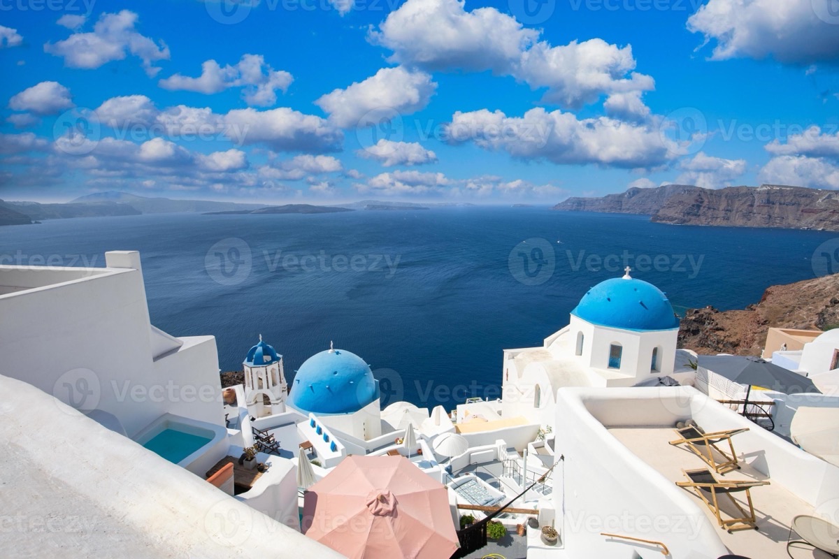 Santorini white village with blue domes in warm morning light