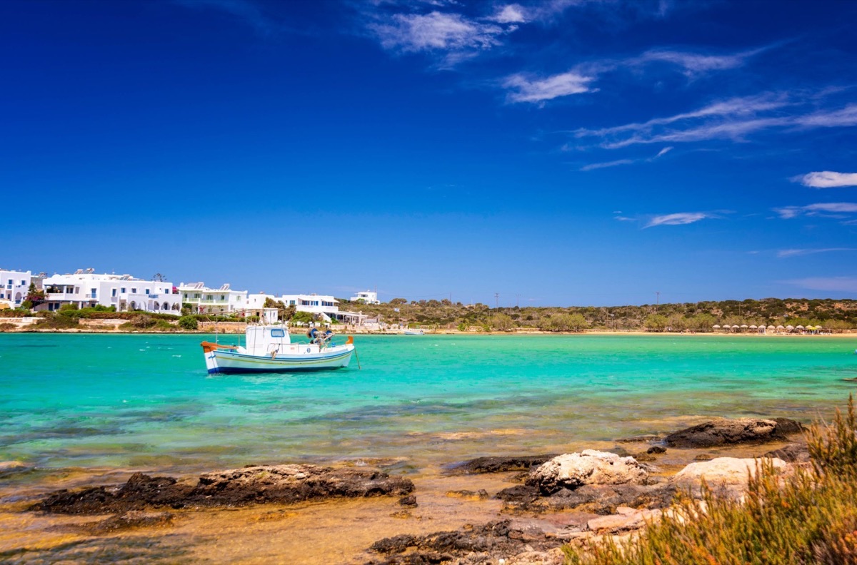 Antiparos island Greece turquoise water with traditional fishing boat