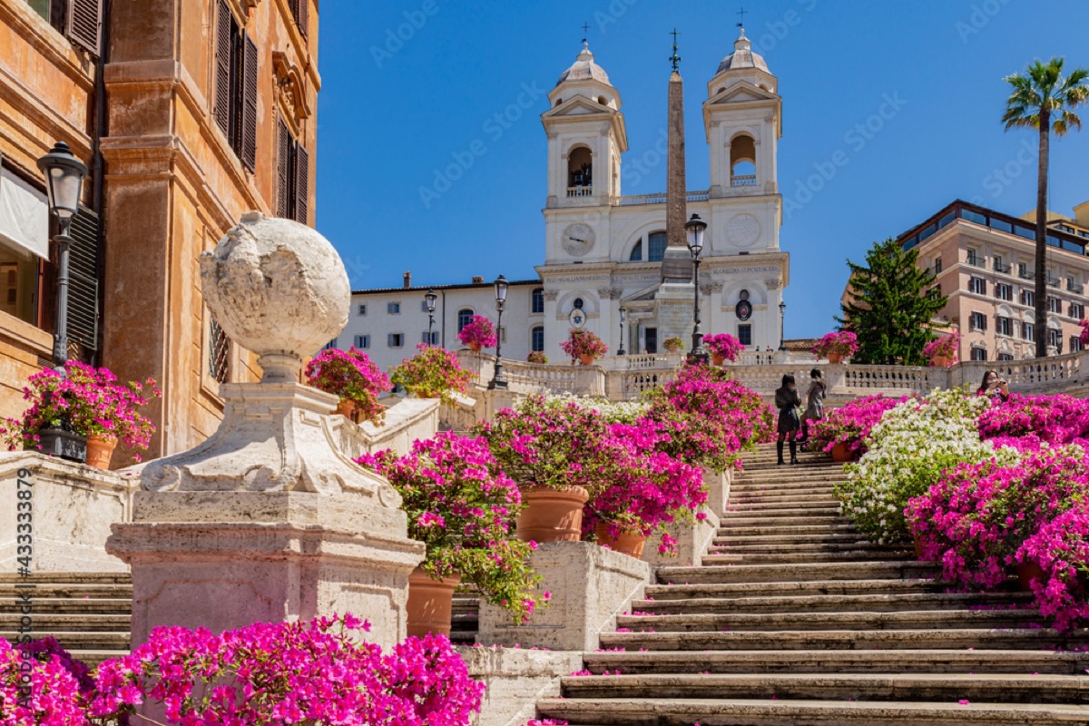 Spanish Steps adorned with flowers below Trinità dei Monti church in Rome